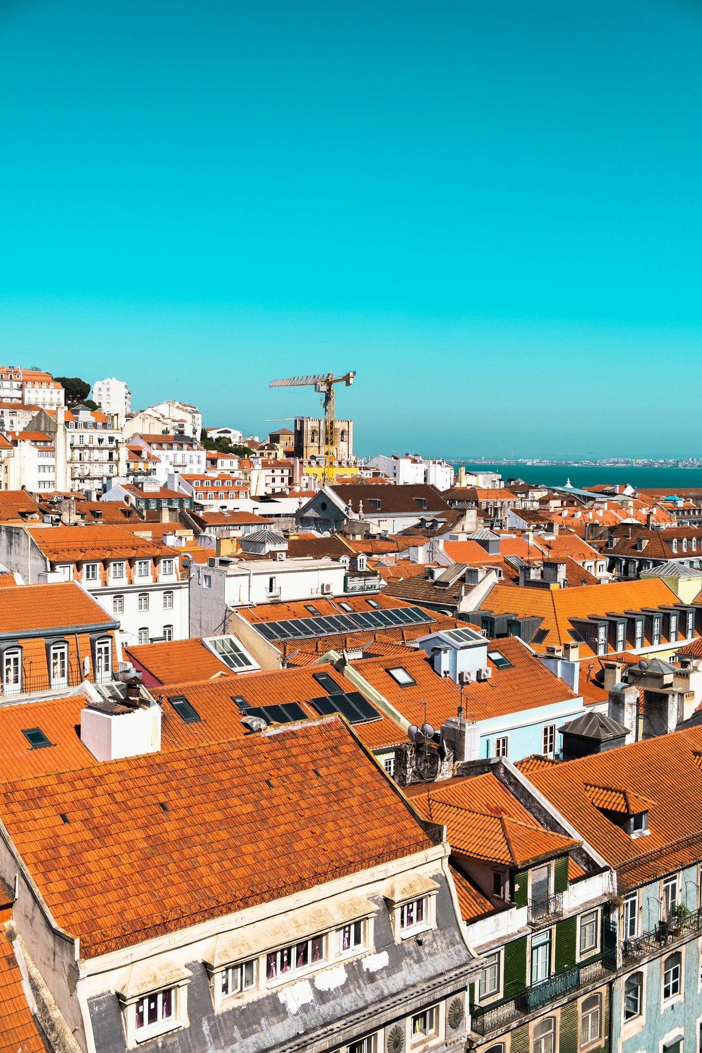 Sunlit rooftops overlooking Lisbon and the Tagus River